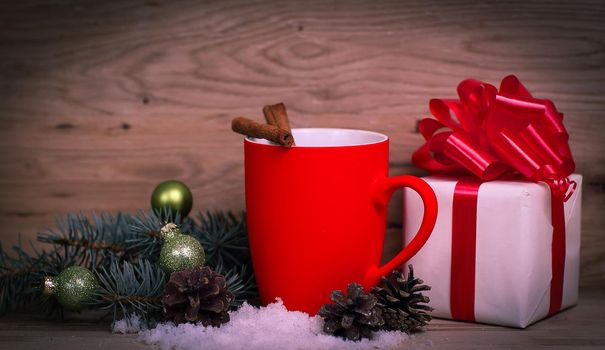 Christmas Cup and the Christmas gift on wooden background.photo with copy space