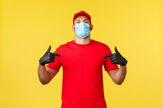 Express delivery during pandemic, covid-19, safe shipping, online shopping concept. Confident and determined courier show-off, ensure carry your parcels safely, pointing himself proud.