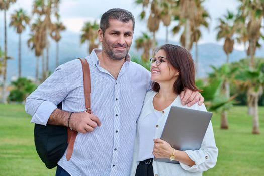 Portrait of a mature couple, smiling man and woman looking at the camera. Business, partners, family, owners, entrepreneurs concept