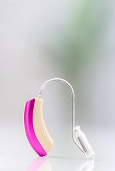 Close-up hearing aid on a light background