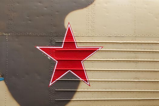 Russian military red star marking on camouflaged helicopter fuselage full frame close-up