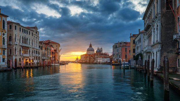 View of the street canal in Venice, Italy. Colorful facades of old Venice houses. Venice is a popular tourist destination of Europe. Venice, Italy.