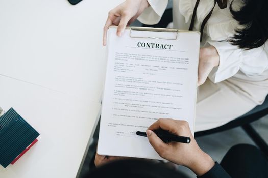 Guarantee, Mortgage, agreement, contract, Signing, Male client holding pen to reading agreement document to sign land loan with real estate agent or bank officer