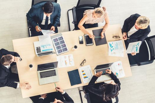 Business people group meeting shot from top view in office . Profession businesswomen, businessmen and office workers working in team conference with project planning document on meeting table .