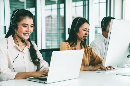 Business people wearing headset working actively in office . Call center, telemarketing, customer support agent provide service on telephone video conference call.