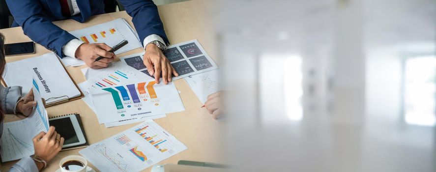 Smart businessman and businesswoman talking discussion in widen group meeting at office table in a modern office interior. Business collaboration strategic planning and brainstorming of coworkers.