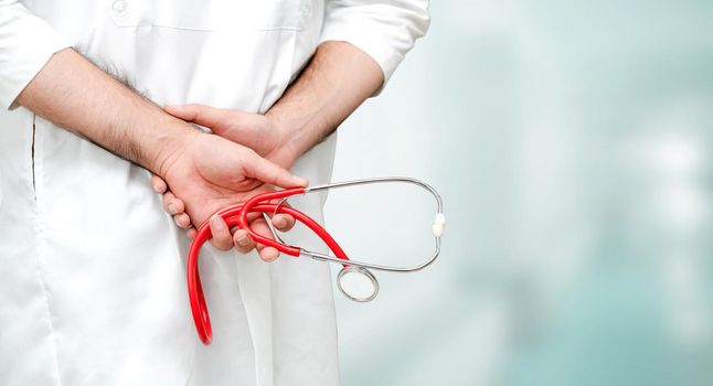 Young male doctor working at the hospital. Medical healthcare and doctor staff service.