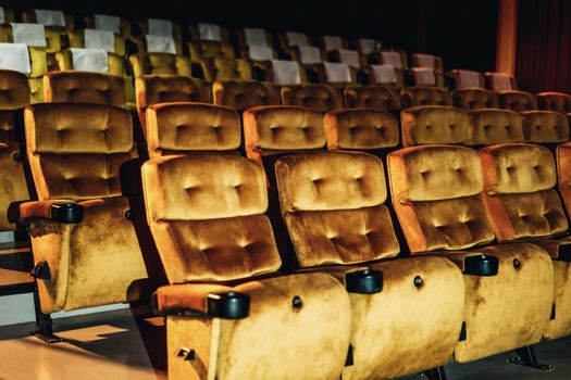 A row of yellow seat with popcorn on chair in the movie theater