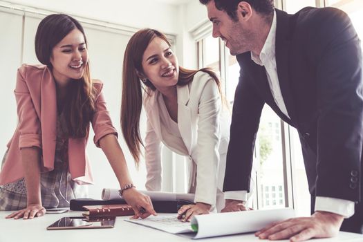 Businessman is in meeting discussion with colleague businesswomen in modern workplace office. People corporate business team concept.