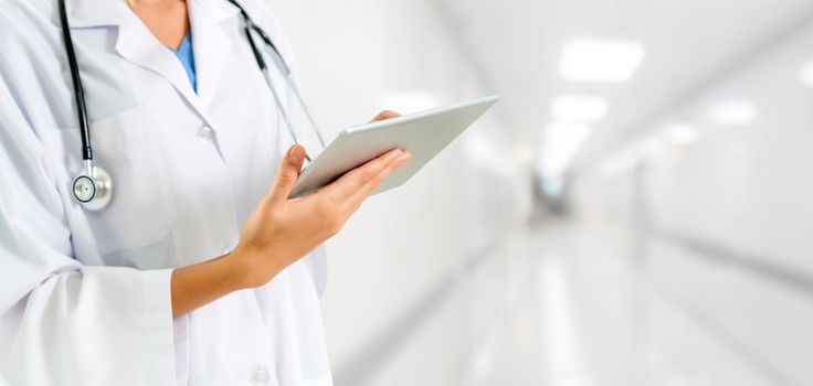 Doctor using tablet computer at the hospital. Medical healthcare and doctor staff service.