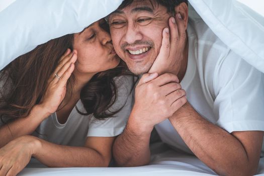 Happy Asian senior couple having good time at home. Old people retirement and healthy citizens elderly concept.