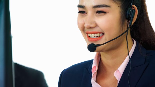 Business people wearing headset working in office to support remote customer or colleague. Call center, telemarketing, customer support agent provide service on telephone video conference call.