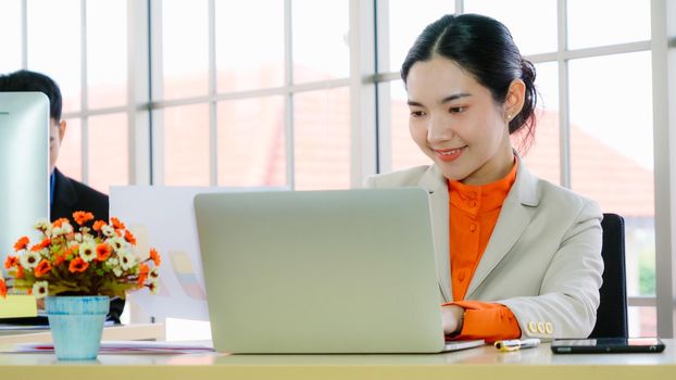 Business people working at table in modern office room while analyzing financial data report .