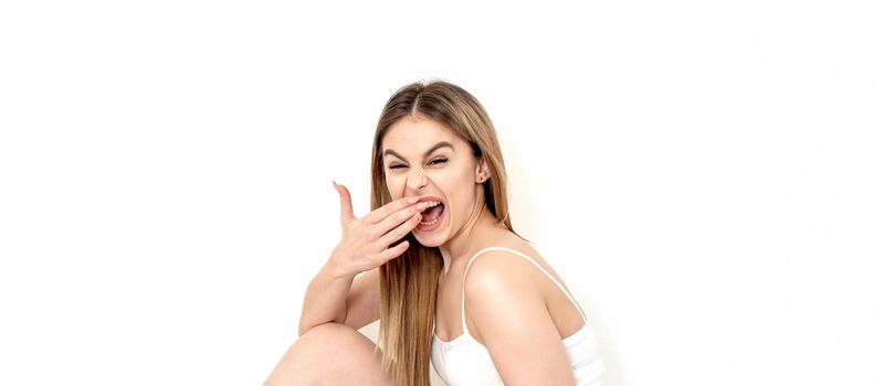 Portrait of beautiful young caucasian woman laughing on white background