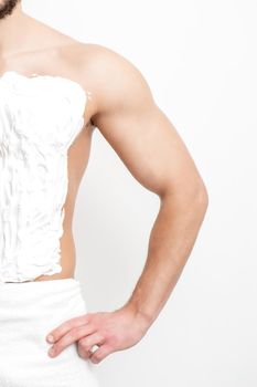 Close up of chest of young white man with shaving foam on white background