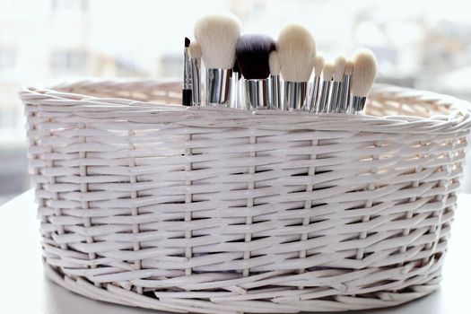 Professional makeup brushes set closeup near salon mirror