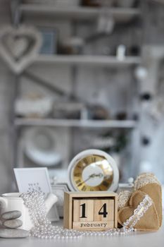 ValentinValentines day concept. heart beside wooden block calendar set on Valentines date 14 February with white clock on table and bright room backgroundes day concept. heart beside wooden block calendar set on Valentines date 14 February with white clock on table and bright room background