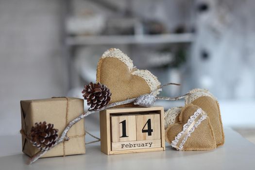 Valentines day concept. heart beside wooden block calendar set on Valentines date 14 February on table and bright room background.