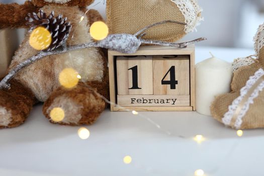 Teddy Bear with heart sitting on wood table, Valentine's day and love concept