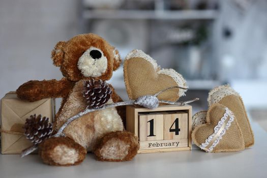 Top view of red heart and pink heart with calendar wooden,teddy bear on blue background,copy space,this image for valentine’s day concept.