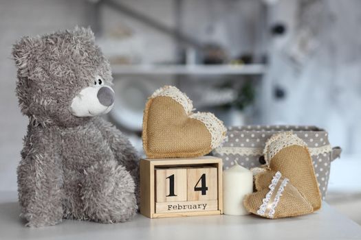 Teddy Bear with heart sitting on wood table, Valentine's day and love concept