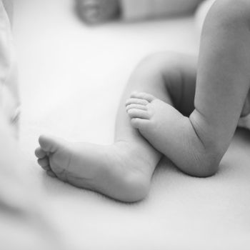 newborn child. baby legs. the legs of the newborn. legs on green background. child's feet