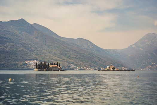 St George Island in the Bay of Kotor at Perast in Montenegro, with St George Benedictine Monastery. St. George Island, is a small natural island off the coast of Perast in Bay of Kotor, Montenegro.