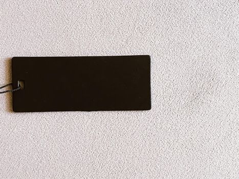 Luxury black fashion label tag, sale price card on fabric background, shopping and retail concept