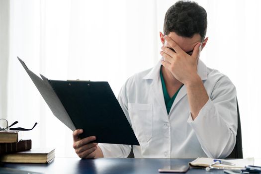 Doctor working in hospital office. Medical healthcare concept.
