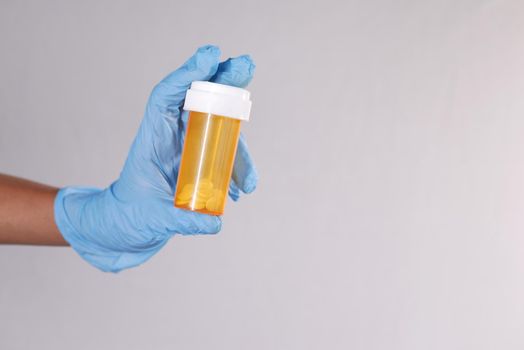 doctor hand holding pill container with copy space .