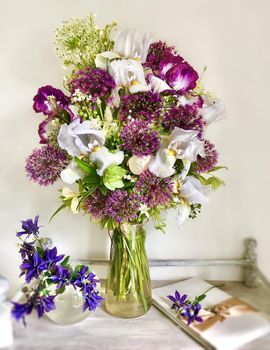 Romantic bouquets of flowers. Home decor and flowers arranging. In composition used aliums, irises and other garden flowers
