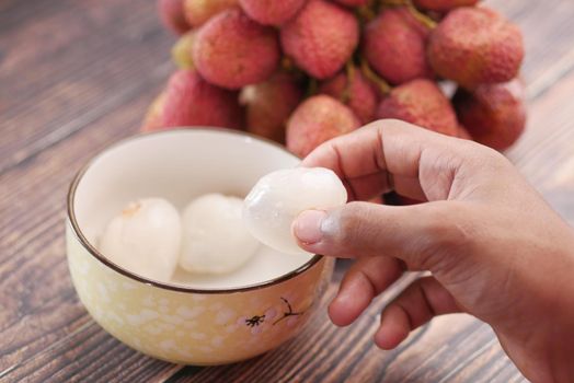 taking skin off from a Lychee fruit ,
