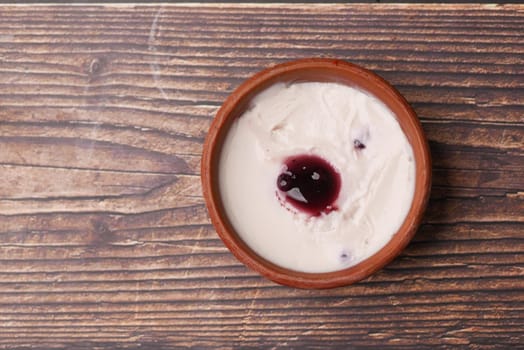 fresh yogurt in a bowl on table .