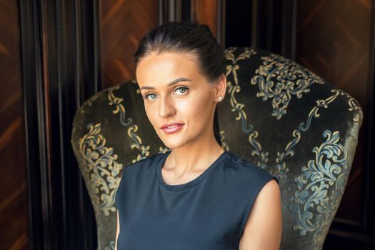 Portrait of business woman working from home sitting on armchair looking at camera. Stay home and quarantine concept.