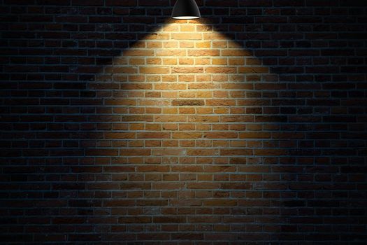 Dark brick wall illuminated by a lamp