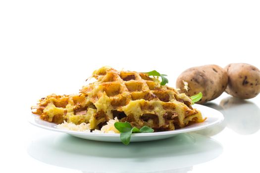 fried potato waffles with cheese in a plate isolated on white background