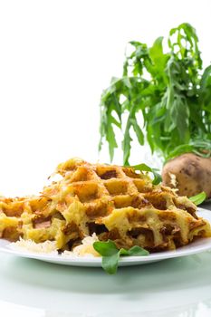 fried potato waffles with cheese in a plate isolated on white background