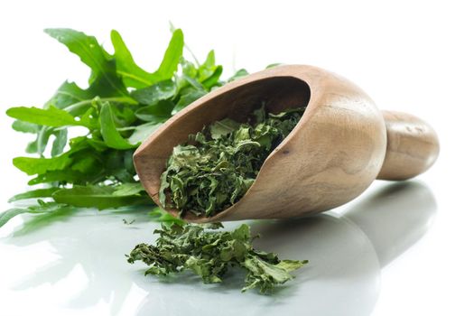 dried green organic arugula, seasoning, isolated on white background.