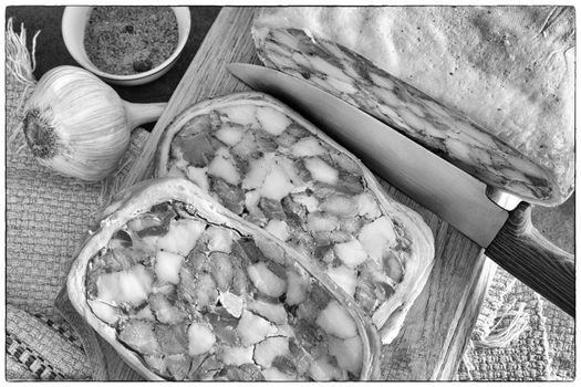 On the table is a delicious meat appetizer: a pork stomach stuffed with meat and lard, cut into slices. Top view, close-up