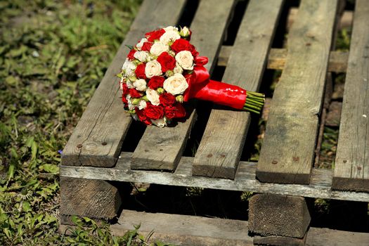 top view of luxury bouquet of red and white flowers top view with red bow on wedding day