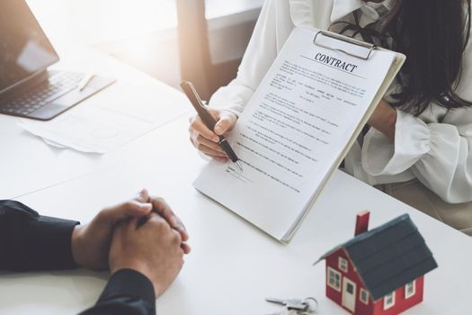 Guarantee, Mortgage, agreement, contract, Signing, Male client holding pen to reading agreement document to sign land loan with real estate agent or bank officer