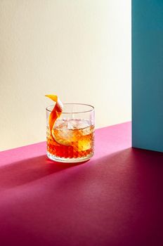 Glass with Whiskey and Ice Cube on Table with Hard Shadows. Modern Isometric Style. Creative Concept.