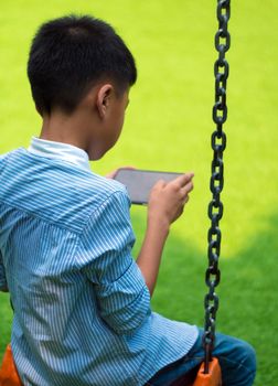 Serious boy playing on smartphone, Children playing game on smartphone