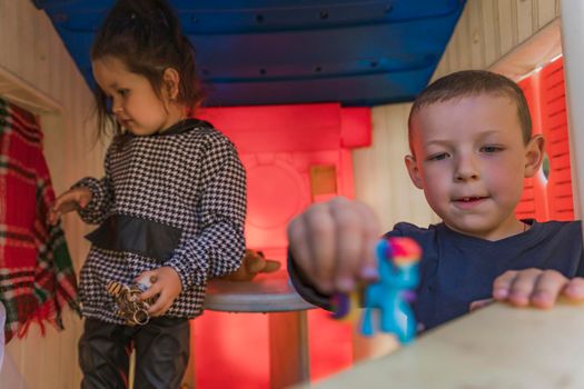 Children play in the children's house with toys