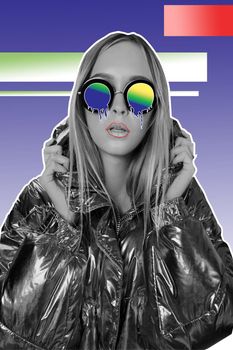 Close-up black and white photo of a beautiful model in a warm shiny jacket and cartoon melting glasses, holding her hood and posing against a gradient background of studio. Art collage.