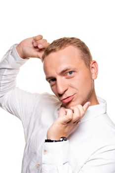 Handsome young blond man in a white shirt is gesticulating, isolated on a white background