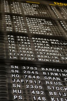 Airport departure board in terminal with flight information