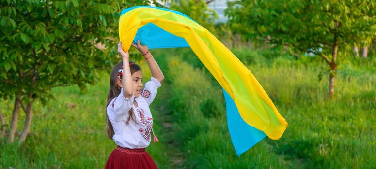 Child with Ukrainian flag patriot stop war. Selective focus. Kid.