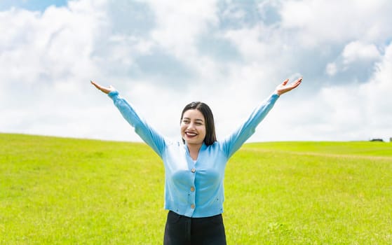Attractive girl spreading her arms in the field, smiling young woman spreading her arms in the field, concept of free woman spreading her hands