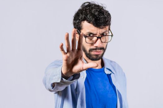 Serious young man stop sign with palm, caucasian man stop sign with hand, stop concept with hand